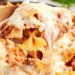 Bow tie Lasagna held by a wooden spoon