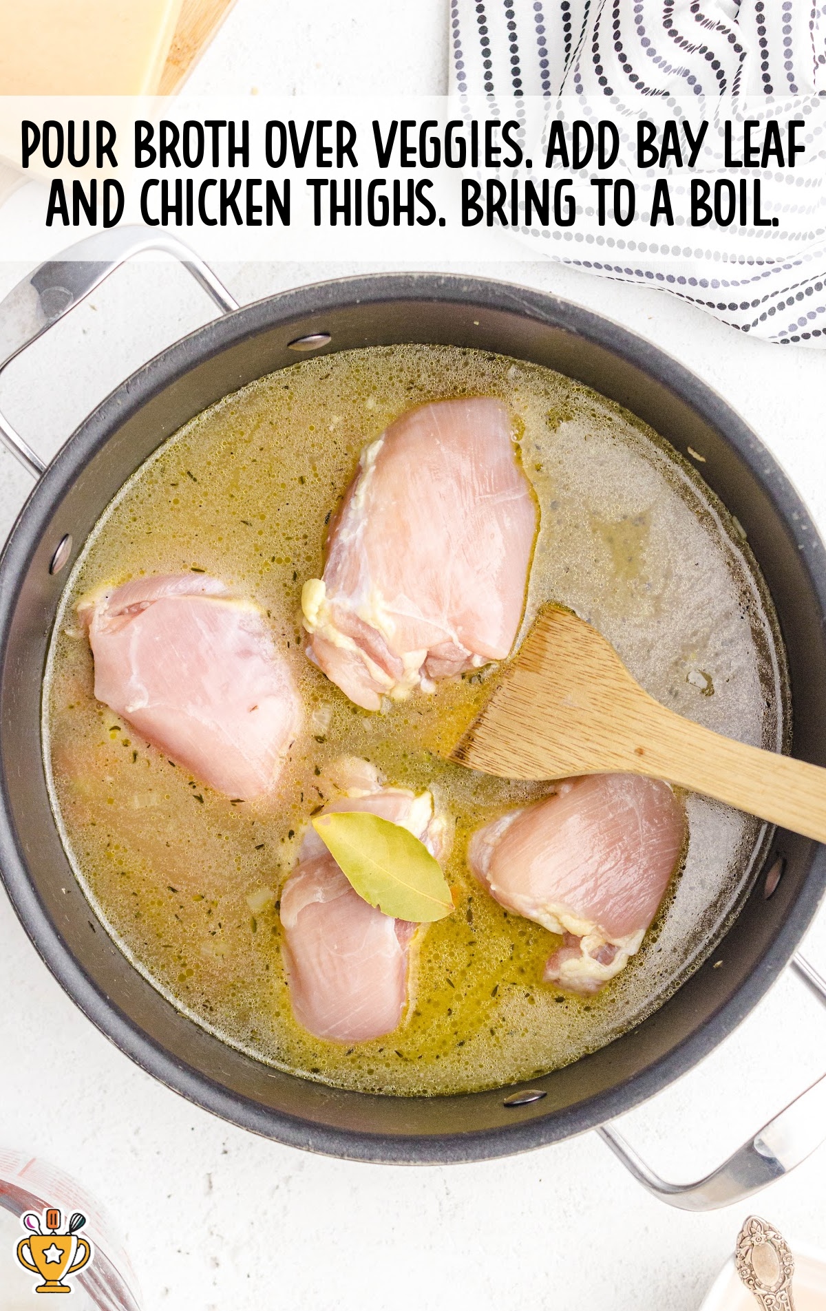 broth, chicken thighs and bay leaf added in a pot