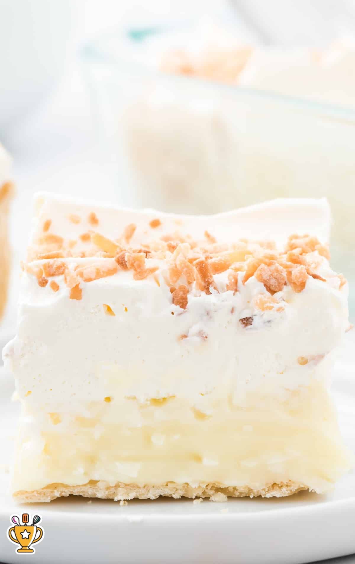 a piece of No Bake Coconut Cream Bars on a white plate