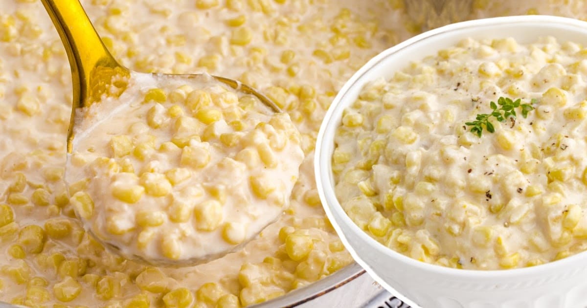 a serving spoon holding some Creamed Corn and some in a bowl