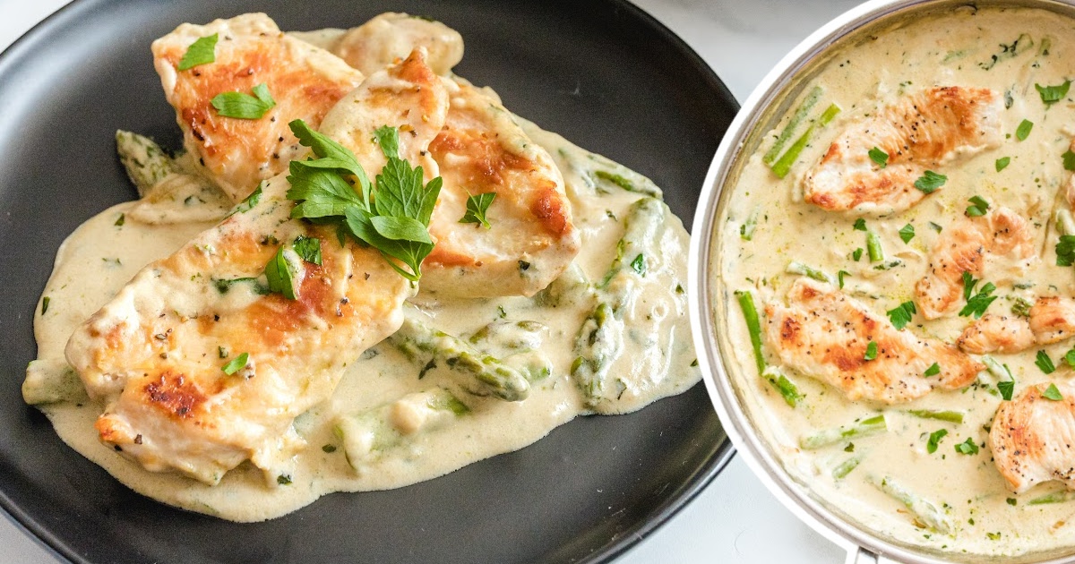 a black plate served with Creamy Chicken and Asparagus