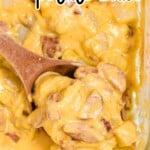 Kielbasa and Potato Casserole in a baking dish with a wooden spoon