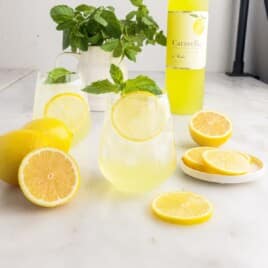 a glass of Limoncello Spritz with slices of lemon on the side