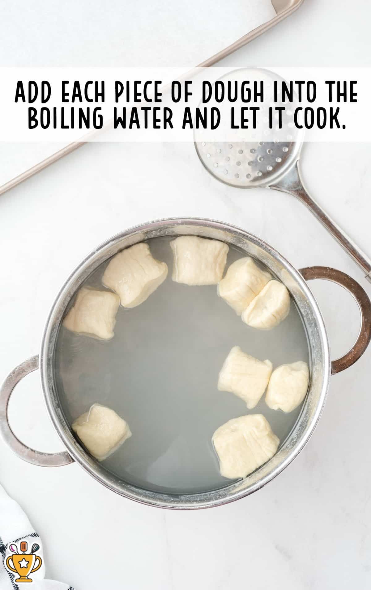 pieces of dough added into the boiling water in a pan