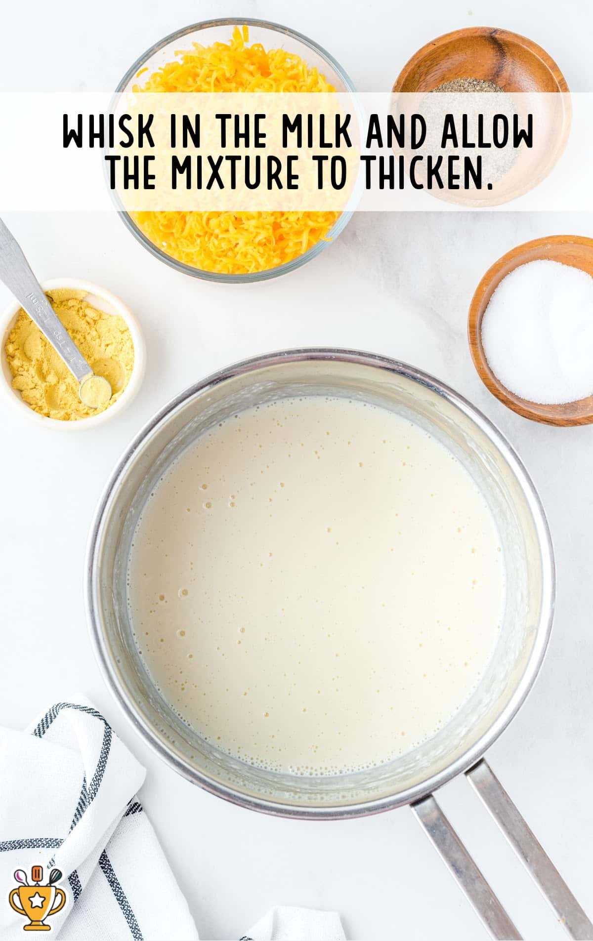 milk whisked in the mixture in a pan