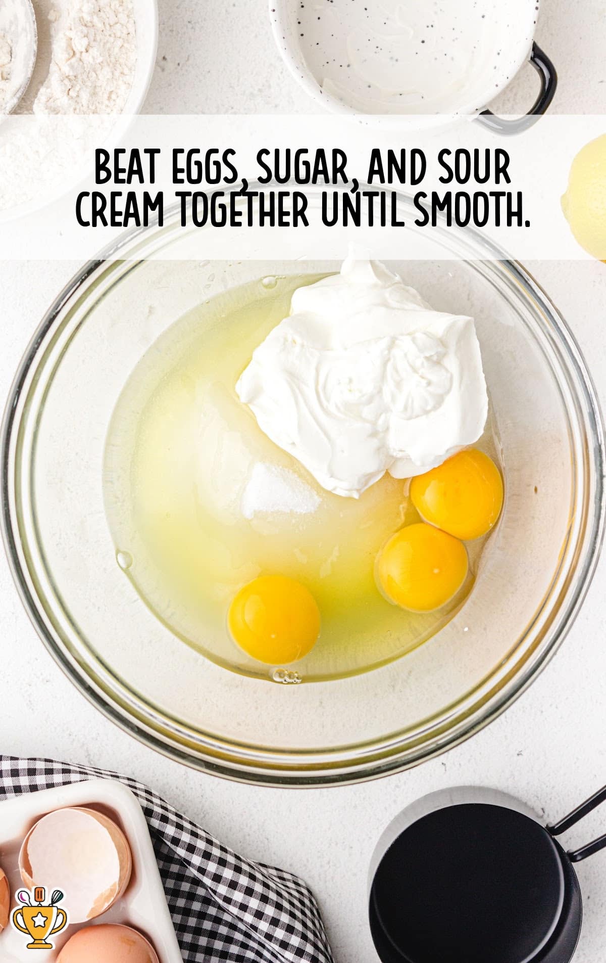 eggs, sugar and sour cream added in a bowl