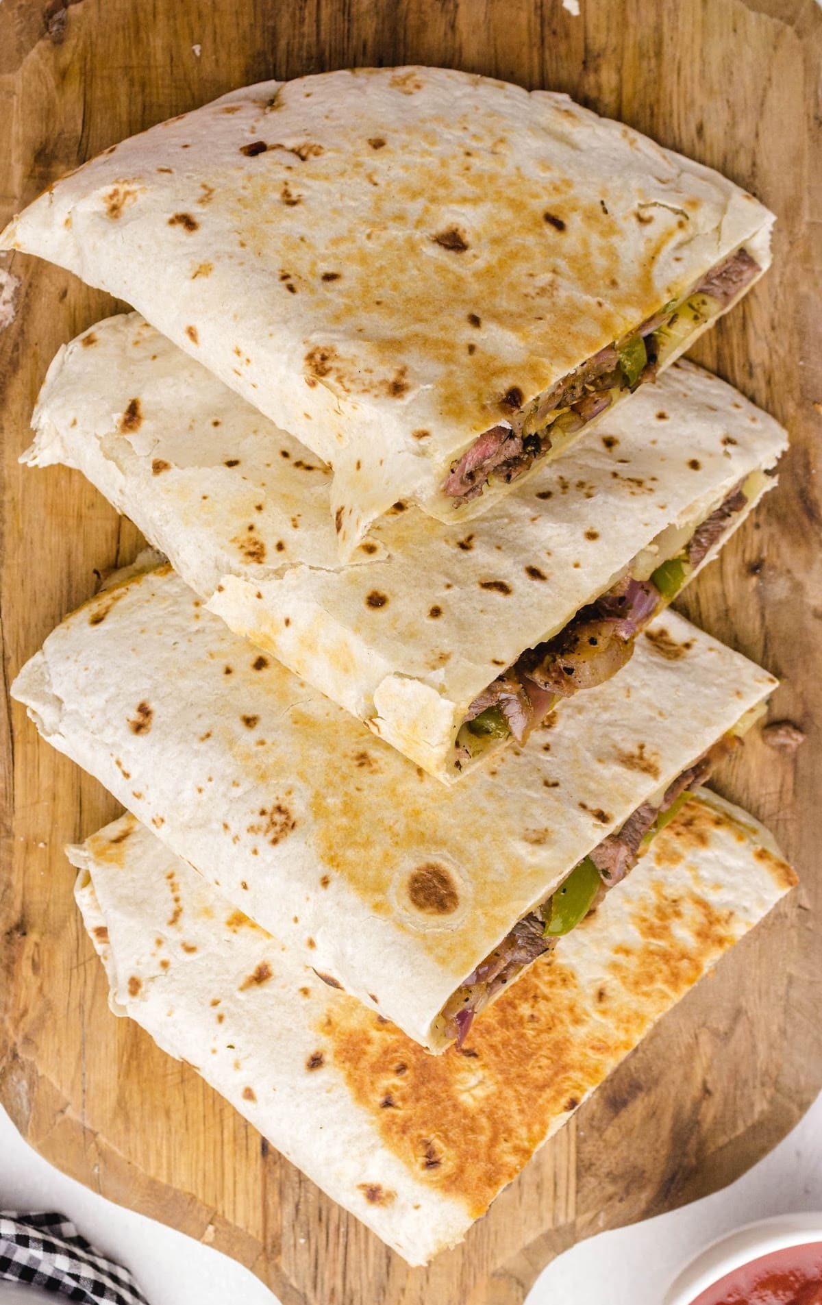 a bunch of Steak Quesadillas on a wooden board