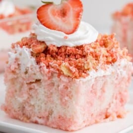 a piece of Strawberry Crunch Poke Cake on a white plate
