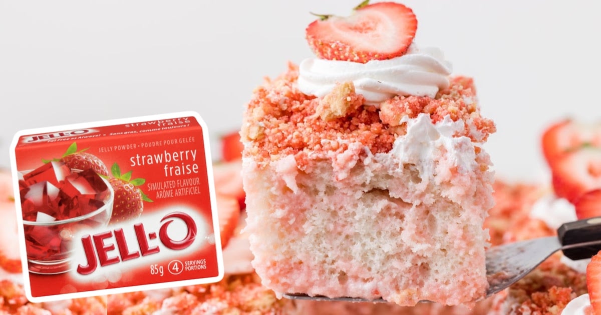 a spatula holding a piece of Strawberry Crunch Poke Cake