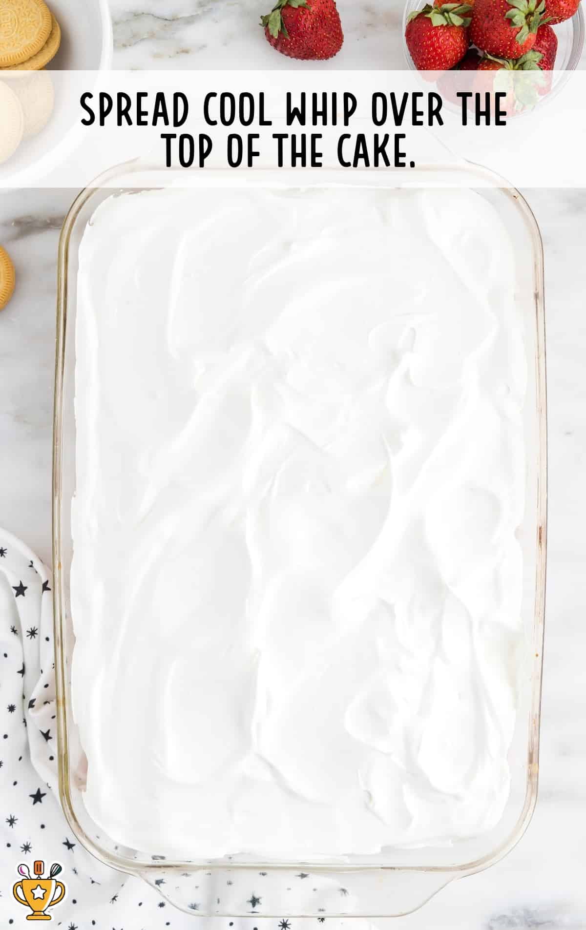 spreading cool whip over the top of the cake