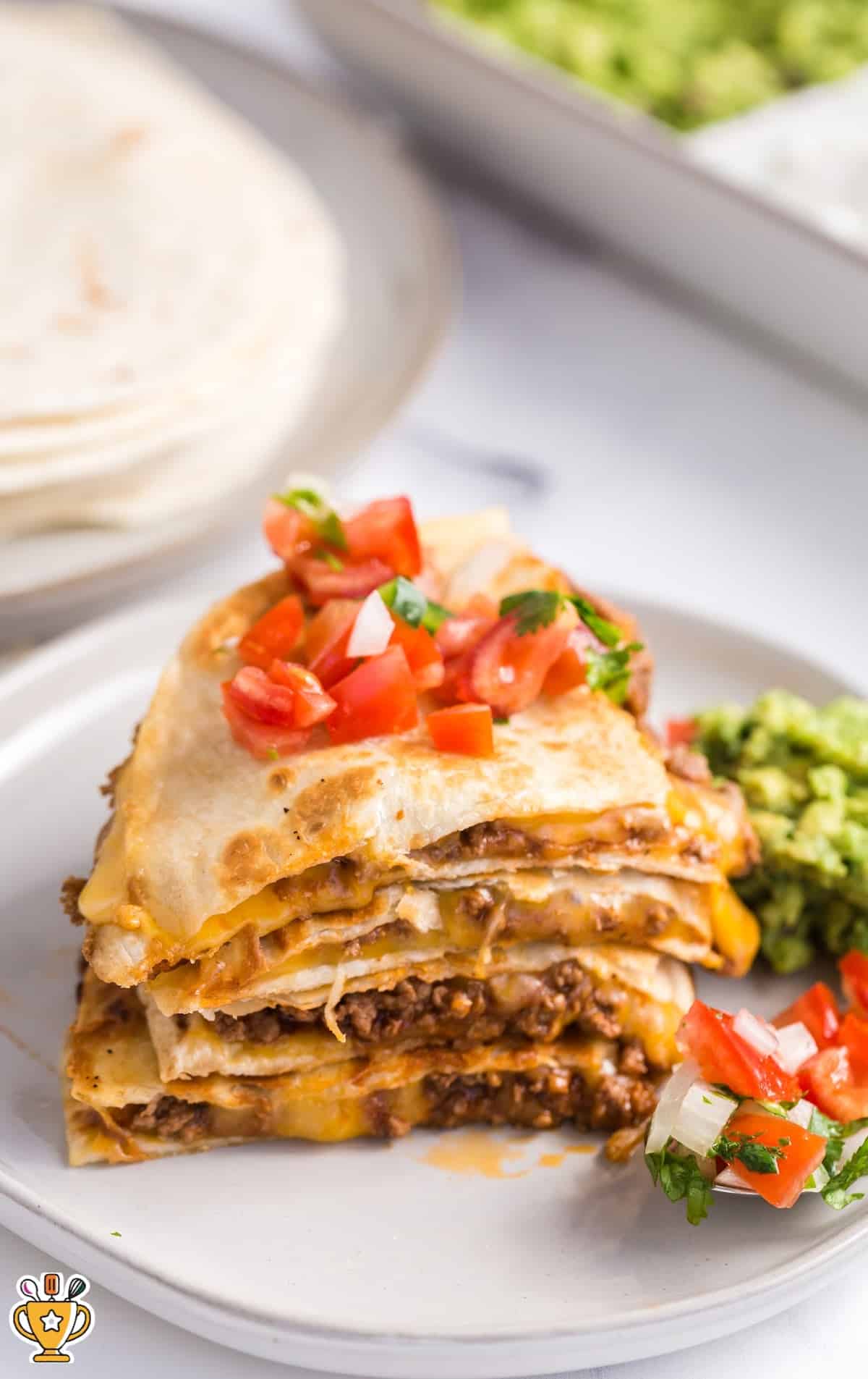 a piece of Cheesy Beef Quesadilla on a plate