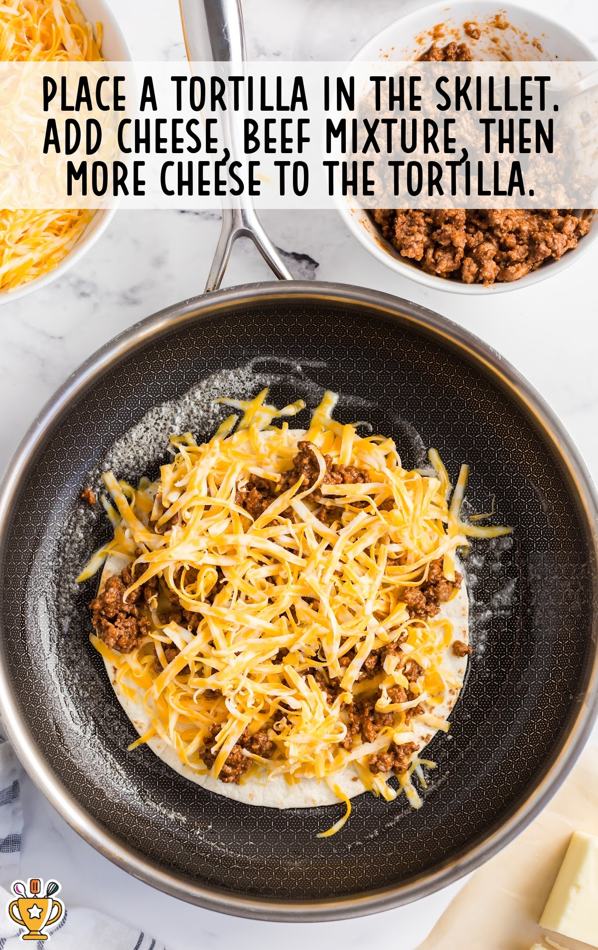 a tortilla placed in the skillet and cheese, beef mixture