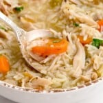a hand holding some Chicken and Rice Soup