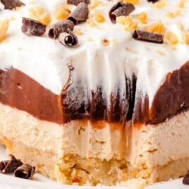 a piece of Chocolate Peanut Butter Lasagna on a white plate