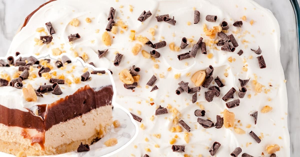 Chocolate Peanut Butter Lasagna in a baking dish and a piece on a plate