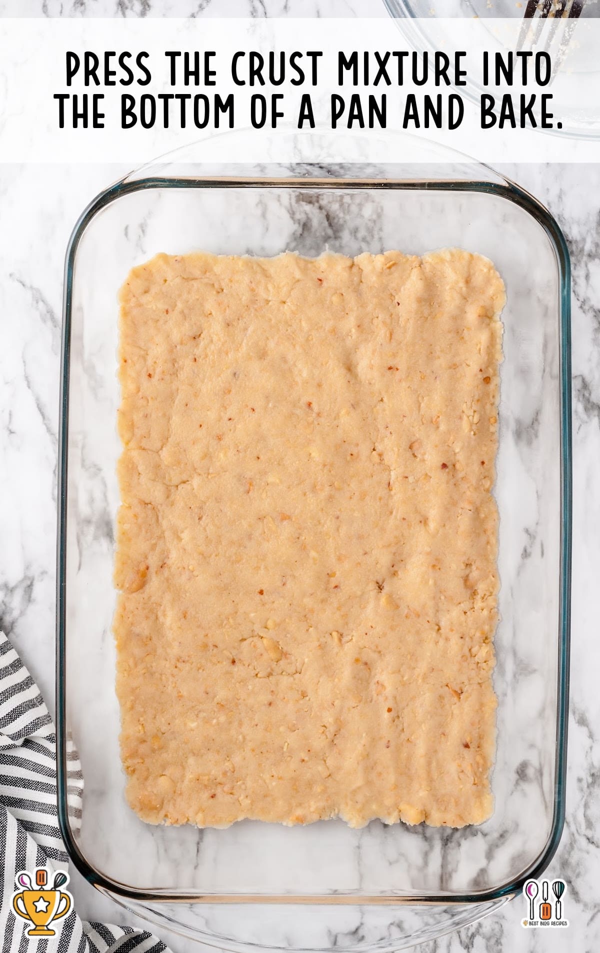 crust mixture pressed into the bottom of a pan ready to bake