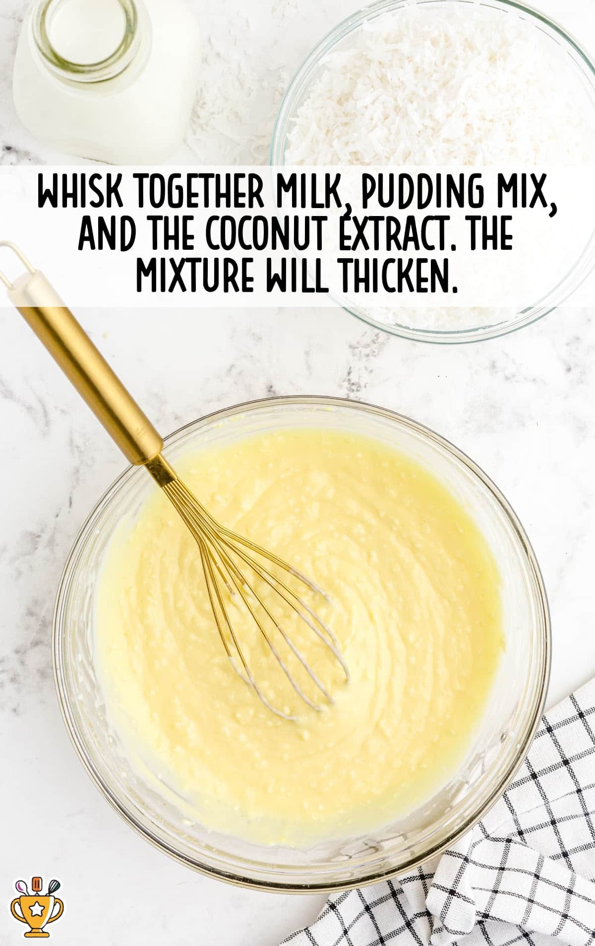 milk, pudding mix and coconut extract mixed together in a bowl with a whisker in it