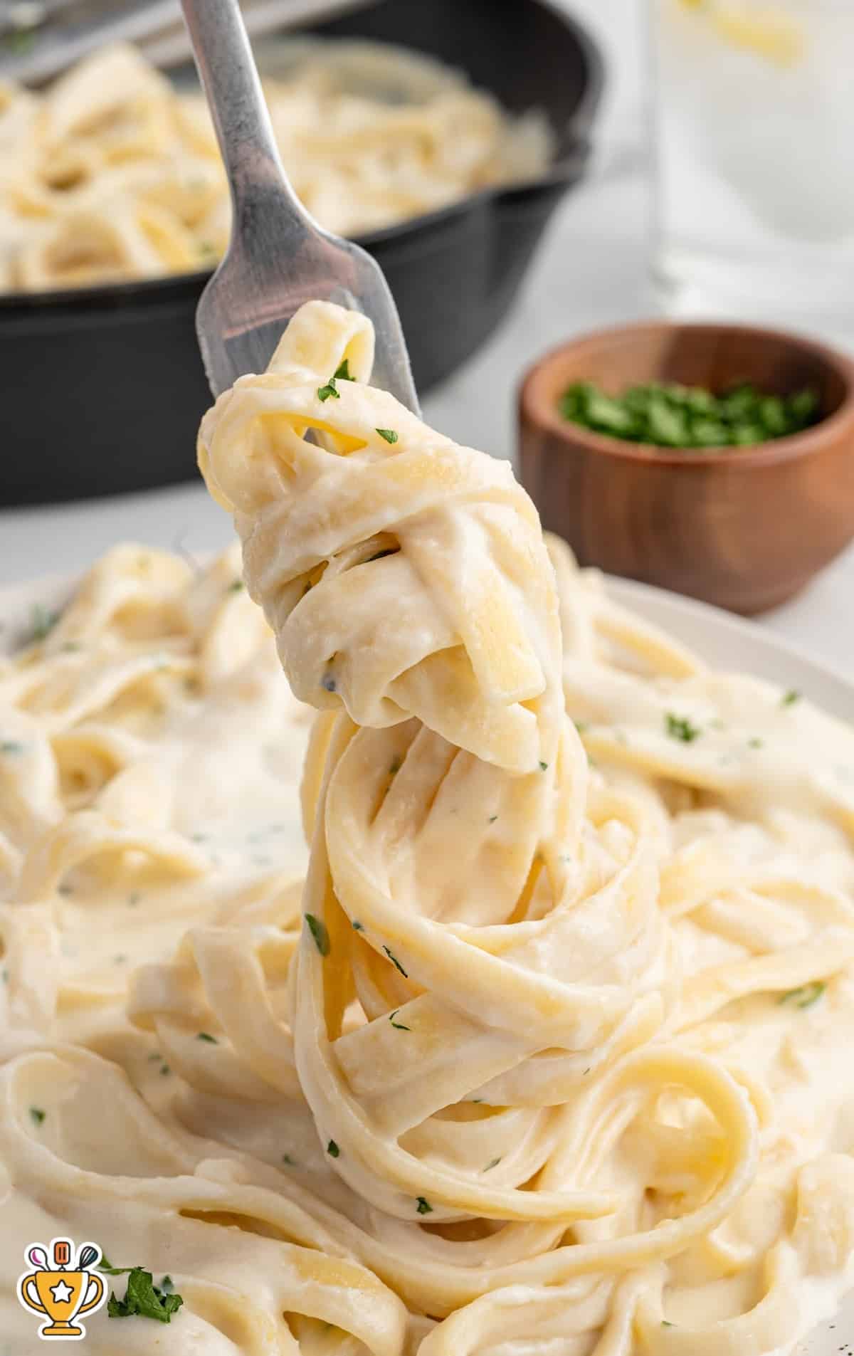 a fork holding some Olive Garden Alfredo Sauce