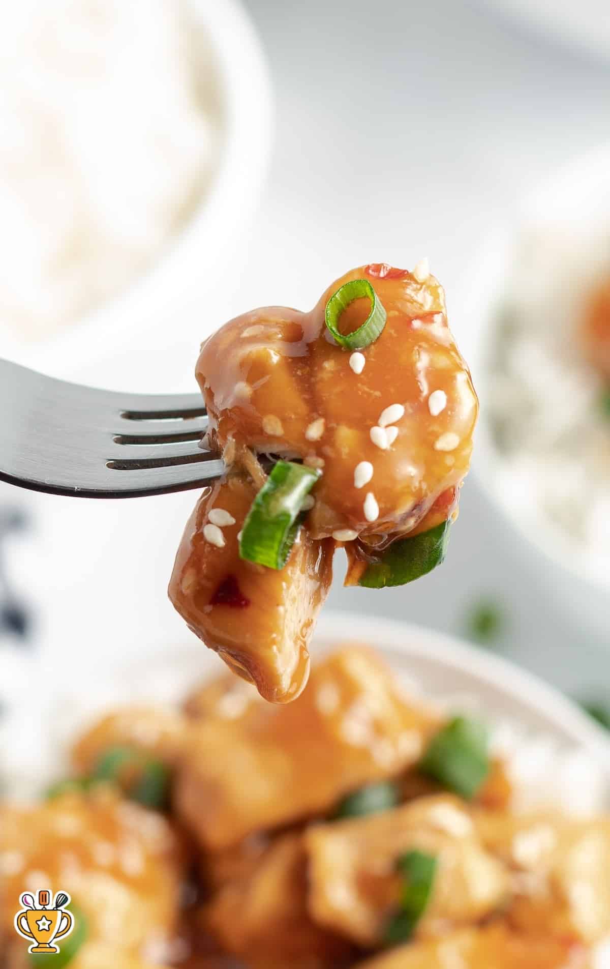 a fork holding some Crockpot Orange Chicken