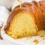 pouring sauce over the Kentucky Butter Cake on a plate