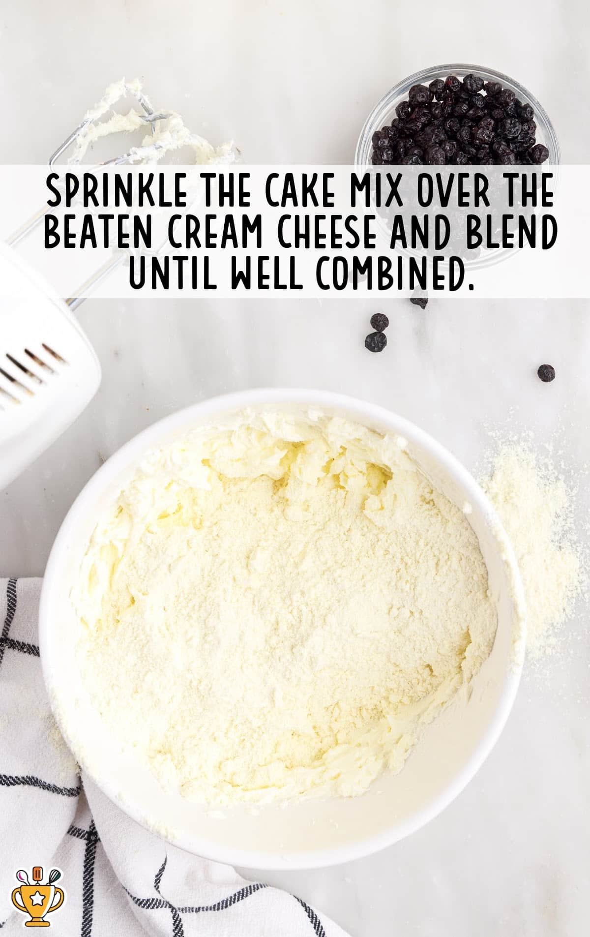 cake mix sprinkled in the beaten cream cheese
