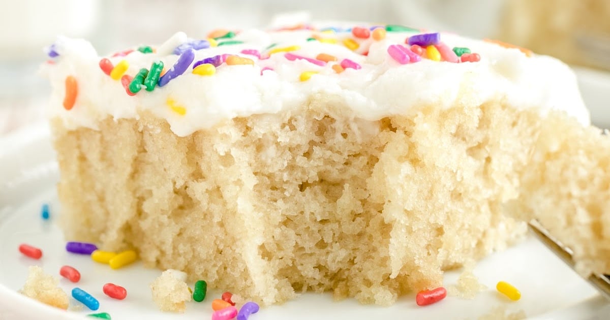 a piece of Vanilla Crazy Cake with a bite on it