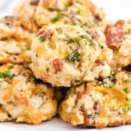 a bunch of Bacon Cheddar Biscuits on a white plate