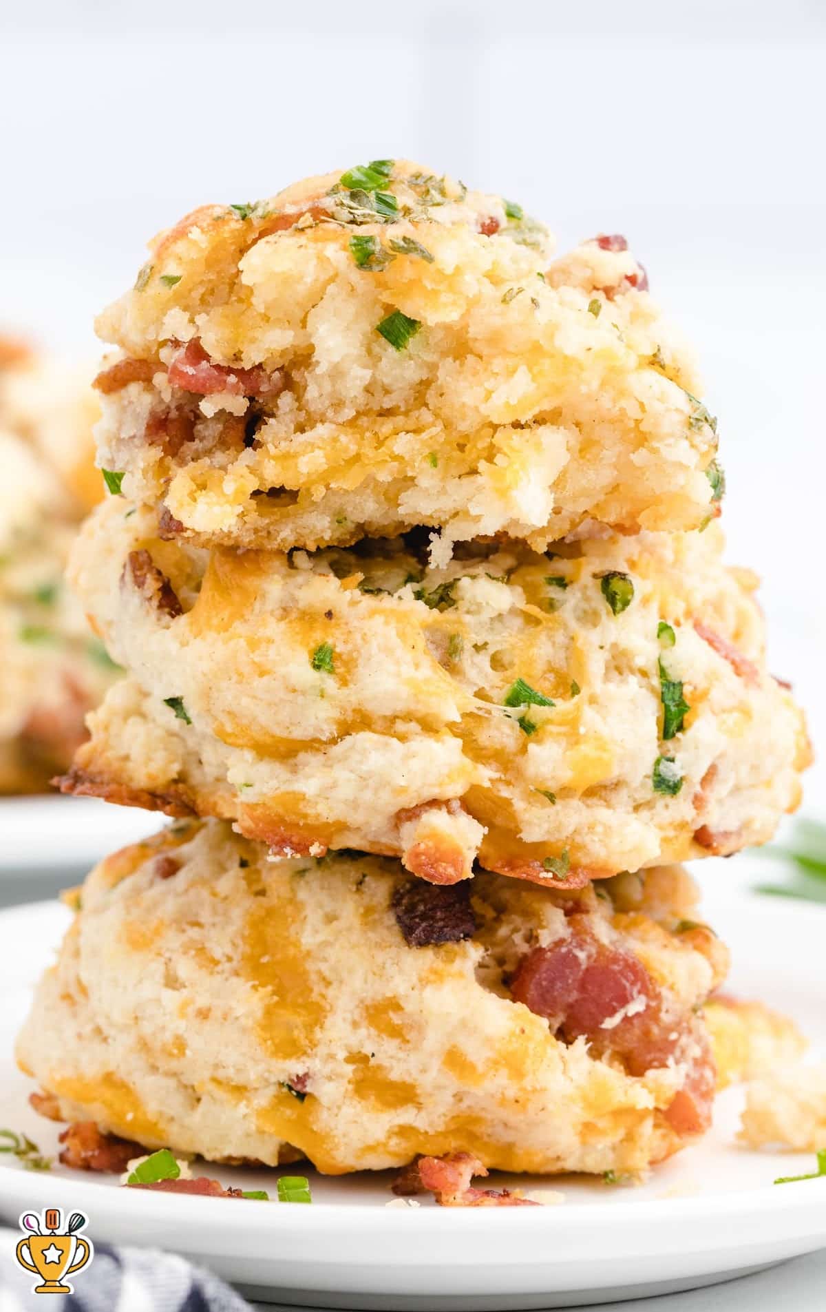 a stack of Bacon Cheddar Biscuits on a plate