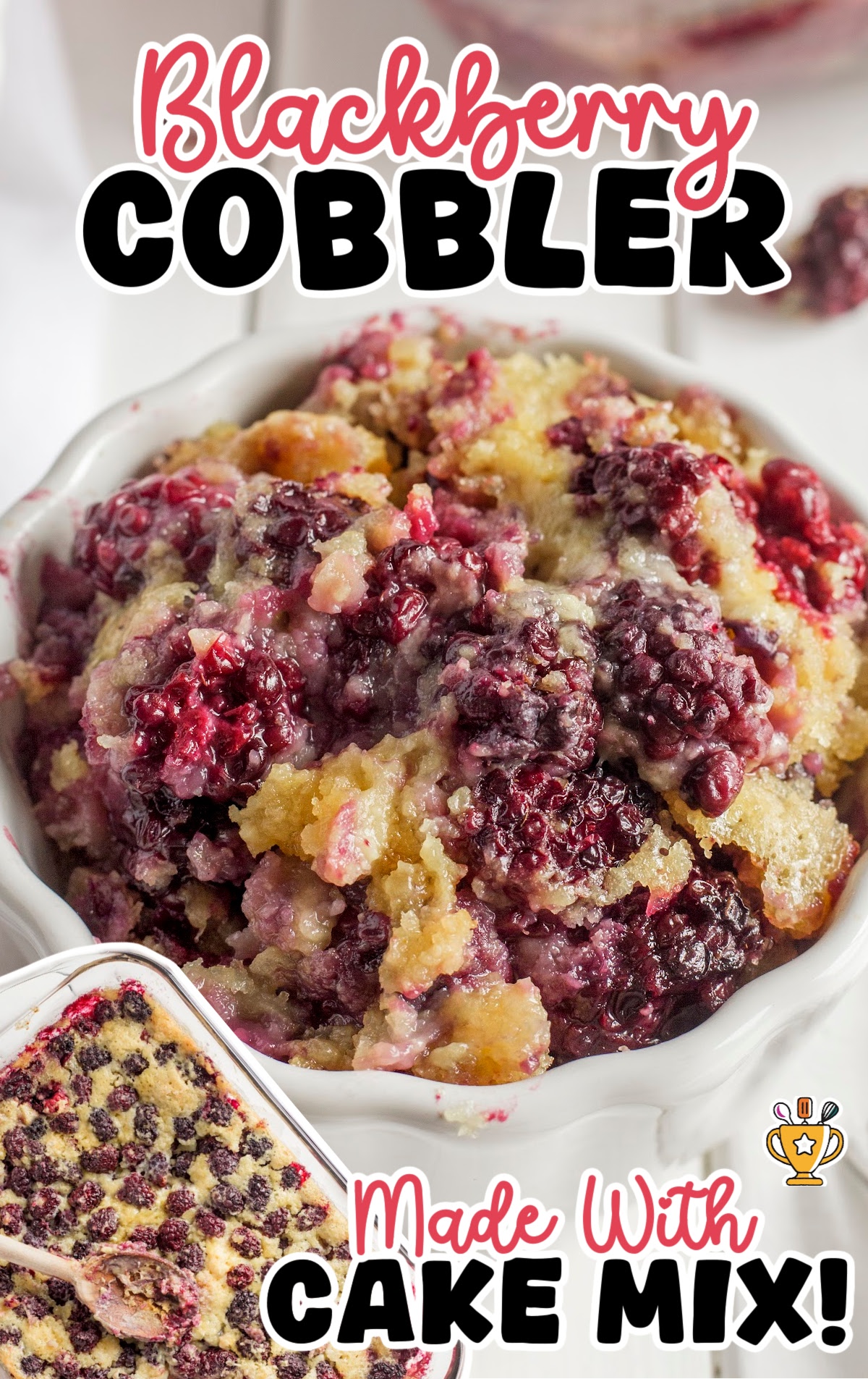 Close-up of spoon in pan of blackberry cobbler showing golden cake and juicy berries.