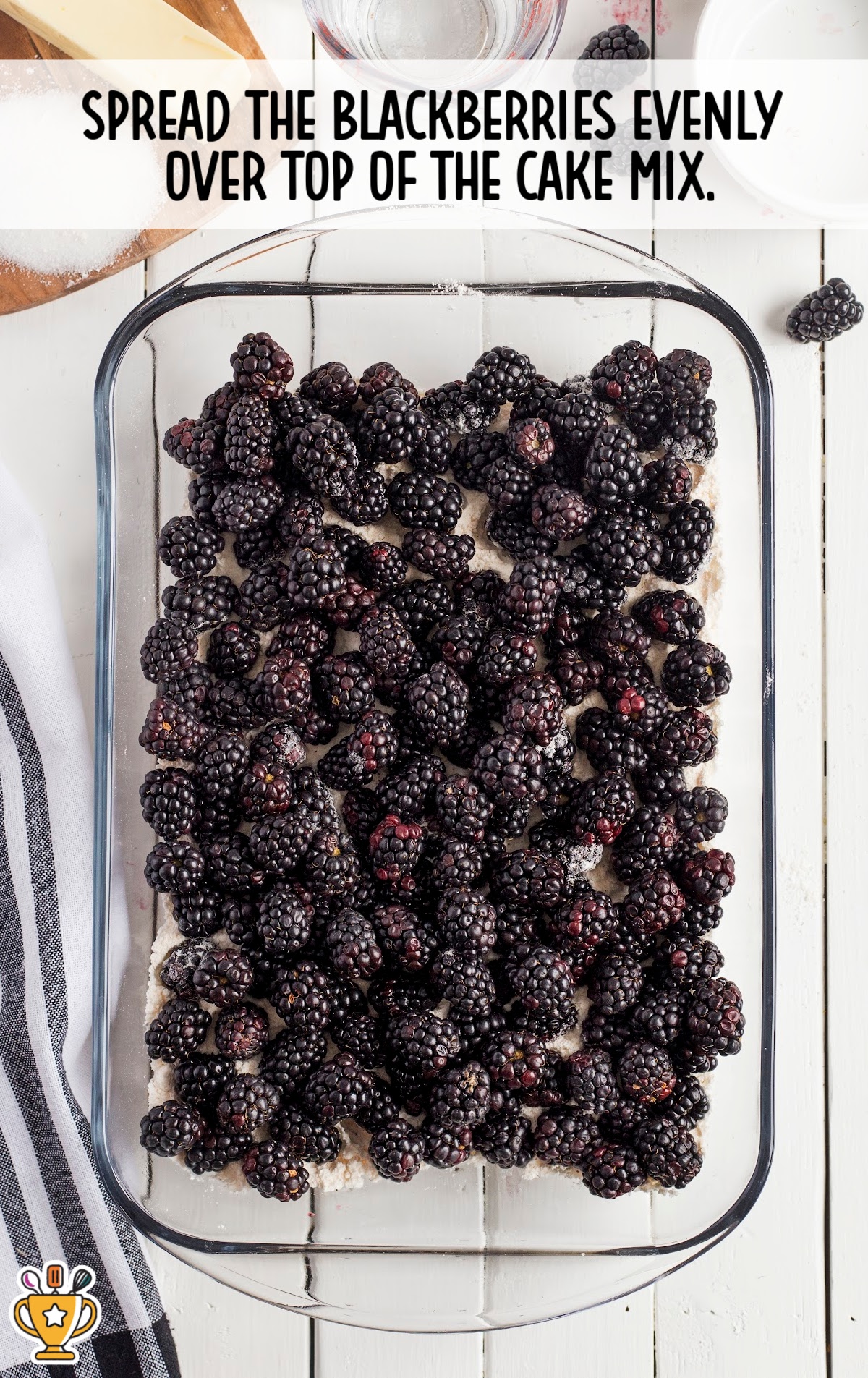 Fresh blackberries layered over cake mix in a glass baking dish