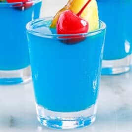 Shot glasses of Blue Hawaiian Jello shots.