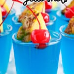 Blue Hawaiian Jello Shots in small shot glasses, garnished with fresh fruit.