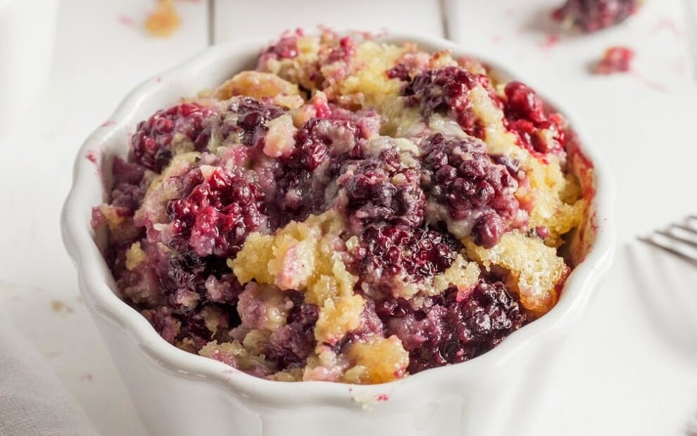 Golden baked blueberry cobbler with bursts of fresh berries and crisp cake edges
