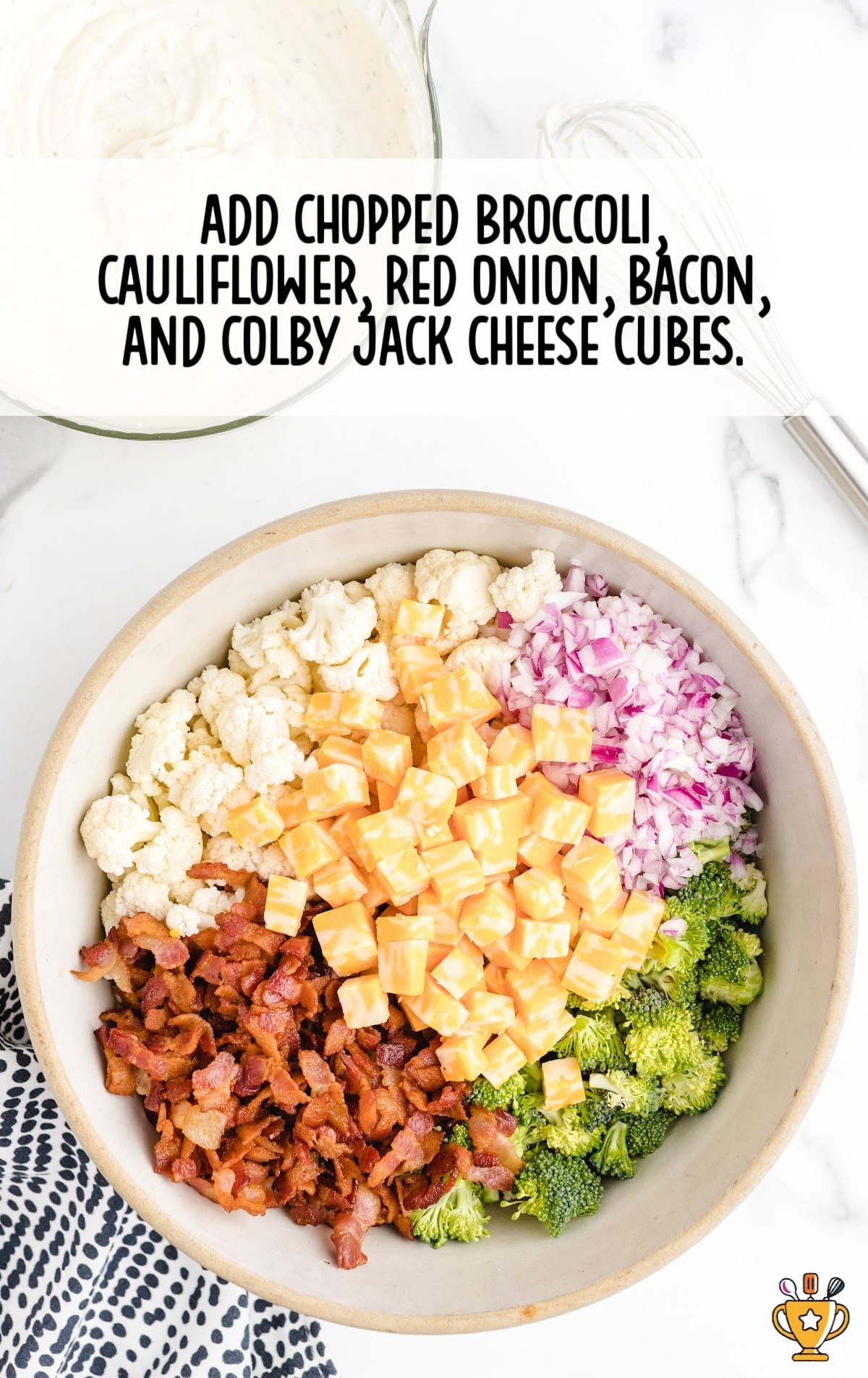 chopped broccoli, cauliflower, red onion, bacon and colby jack cheese cubes in a bowl