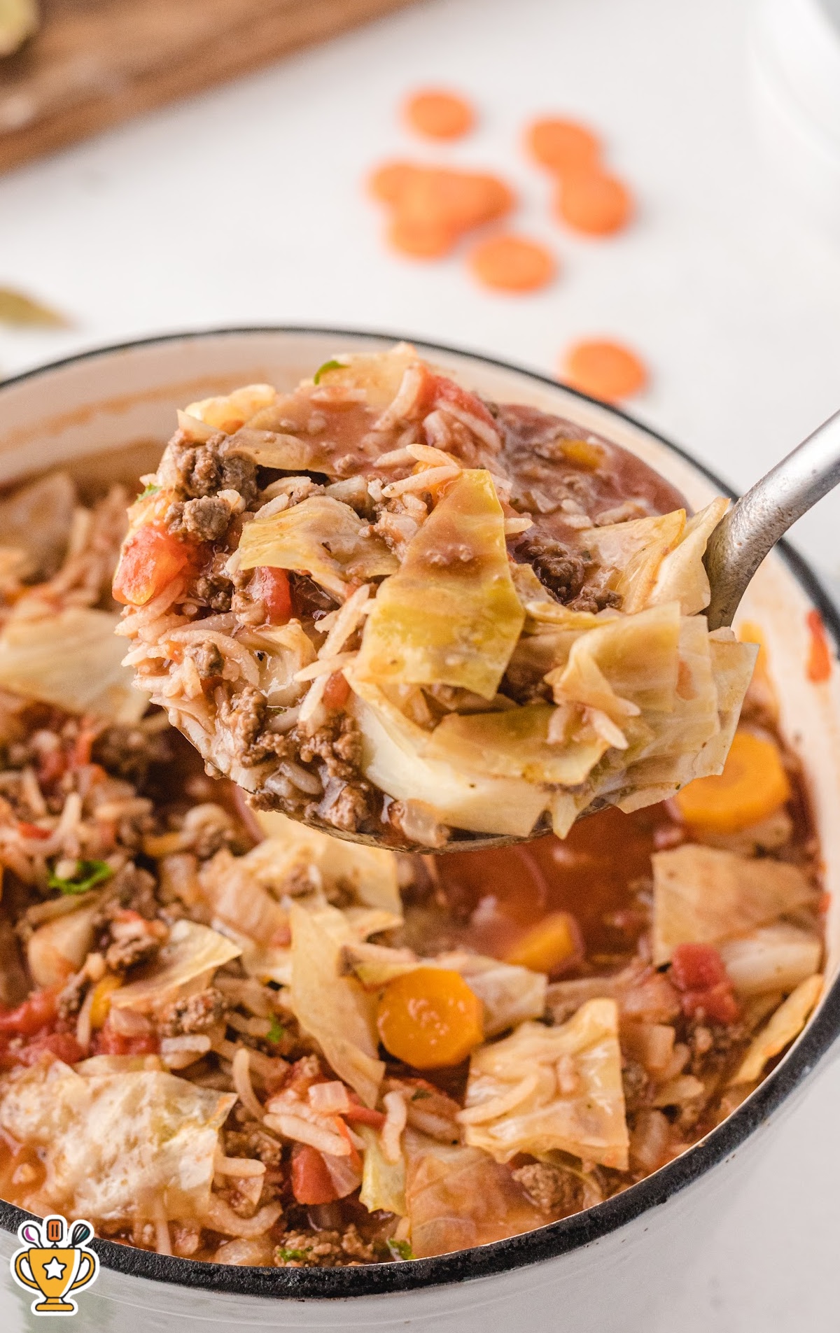 Cabbage Roll Soup in a pan and a spoon holding some