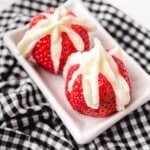 two Cheesecake Stuffed Strawberries on a plate