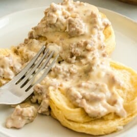 Country Biscuits and Sausage Gravy served on a plate with a fork