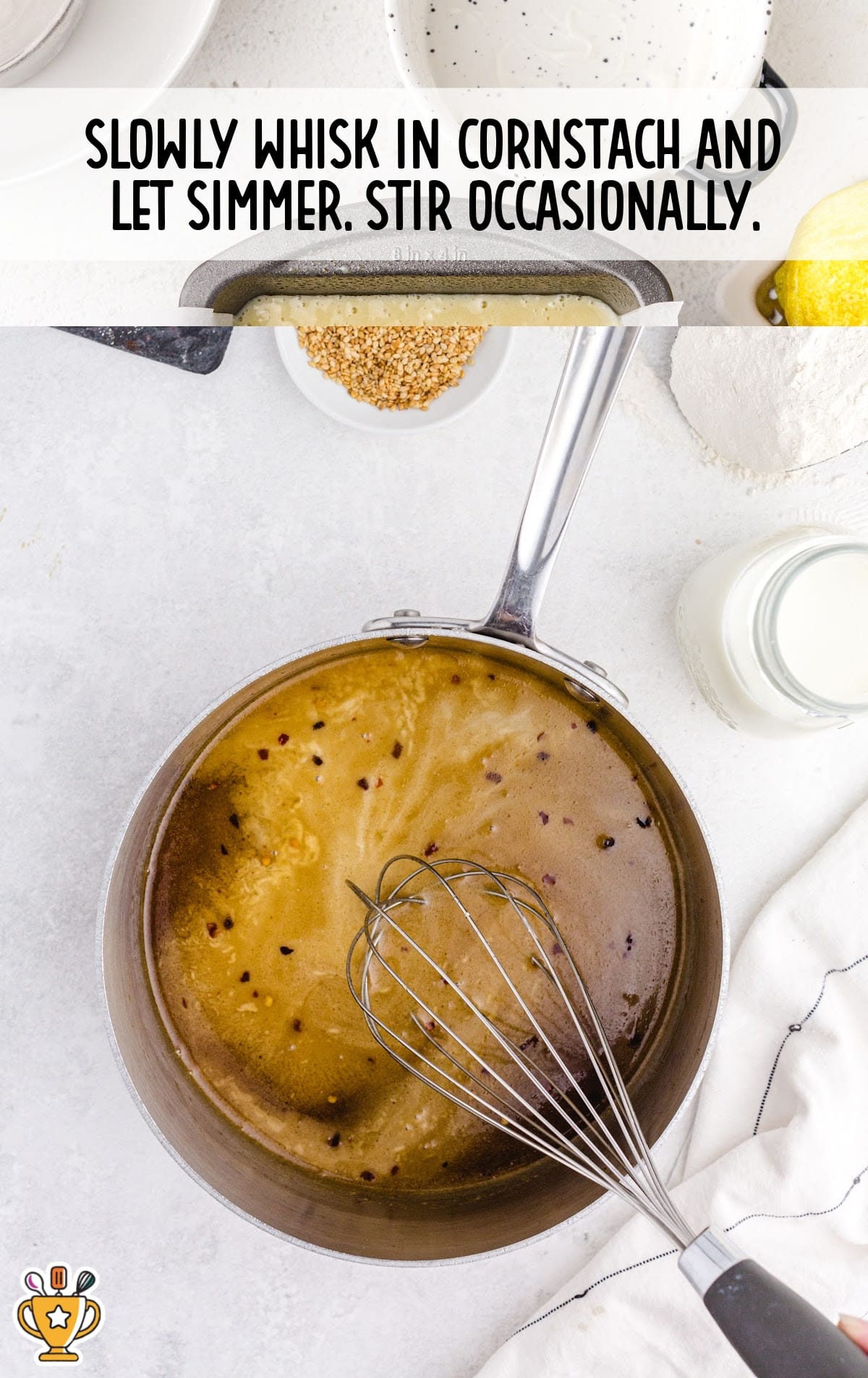 Sauce being whisked in a saucepan with red pepper flakes visible in the mixture.