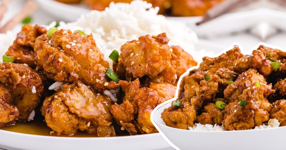&ldquo;Side view of crispy fried honey chicken in bowls over rice, coated in a shiny sauce, garnished with scallions.&rdquo;