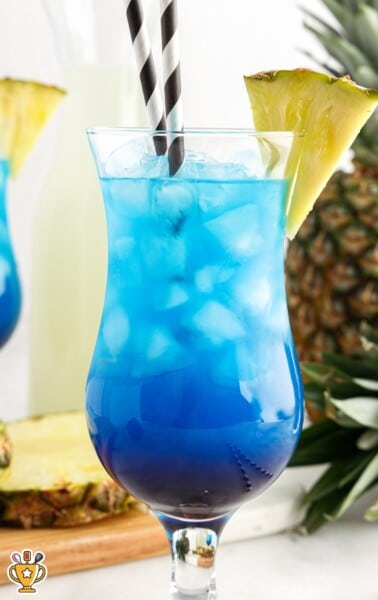 a glass of Fruit Tingle with two straws in it