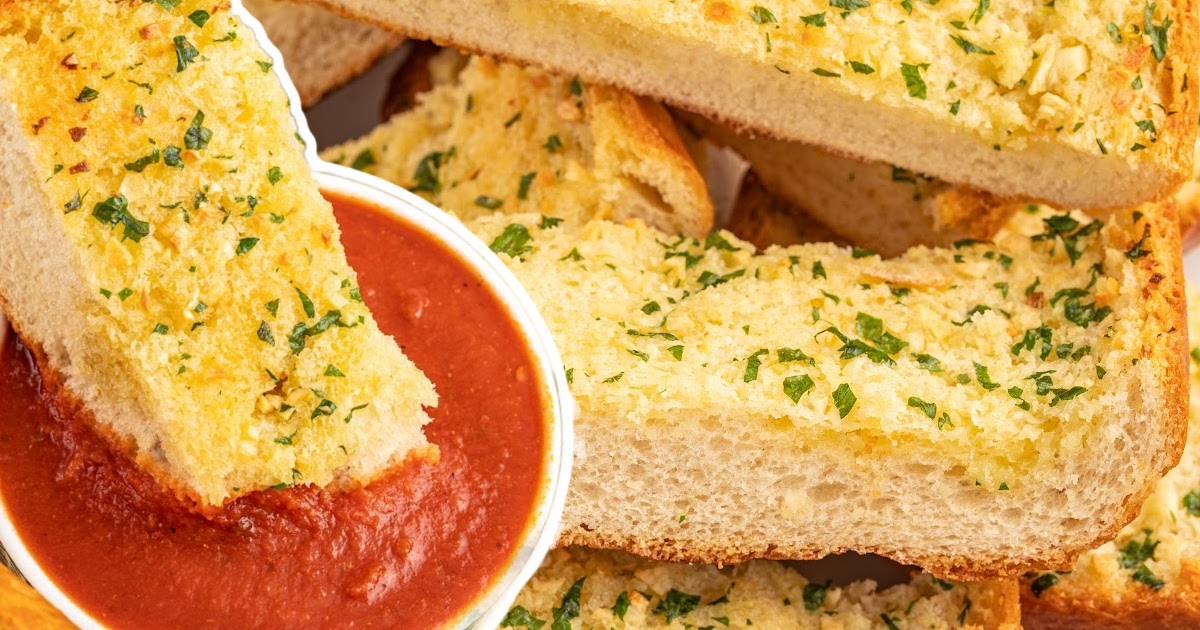 pieces of Garlic Bread and a piece of Garlic Bread dipped in a bowl of sauce
