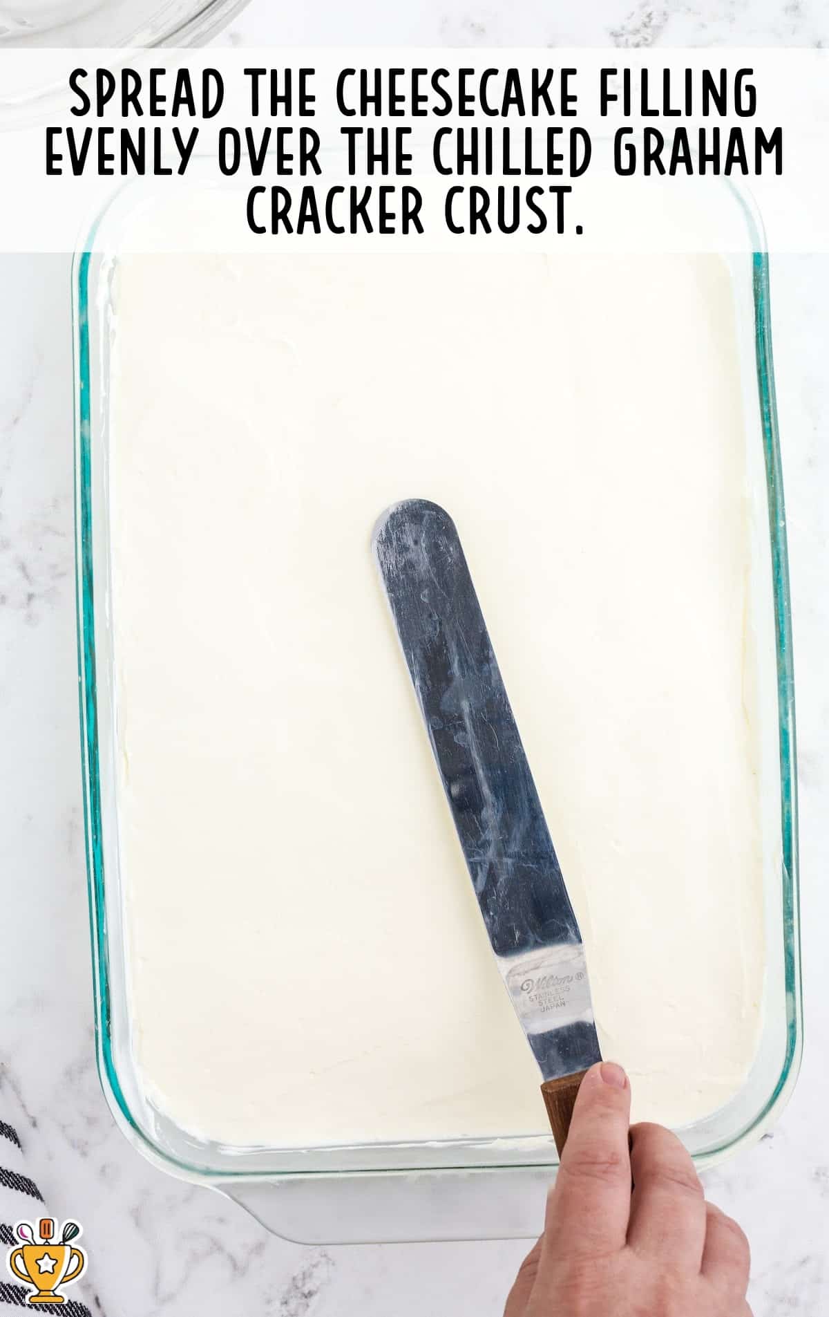 spreading the cheesecake filling over the chilled graham cracker crust