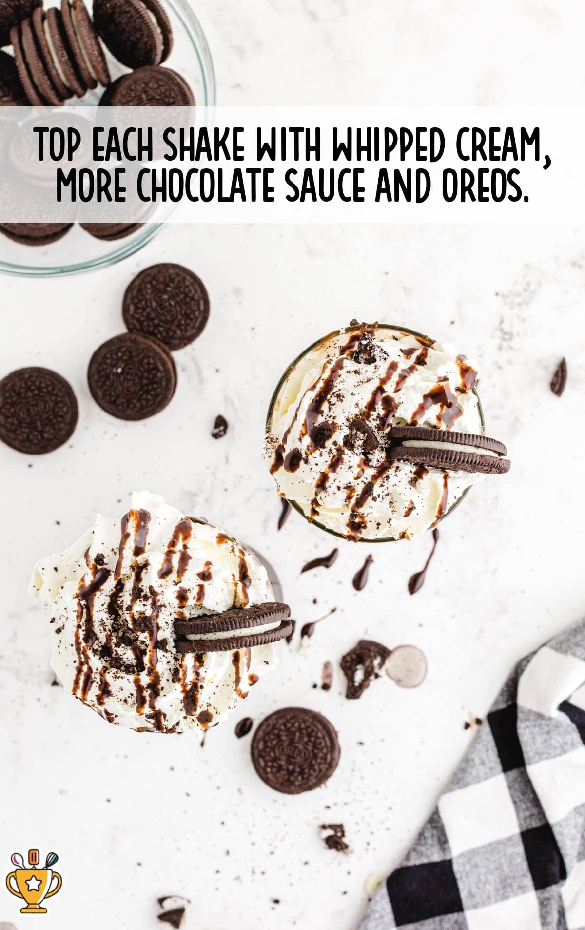 whipped cream, chocolate sauce and oreos topped on glasses