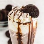a glass full of Oreo Milkshake with an oreo cookie in it