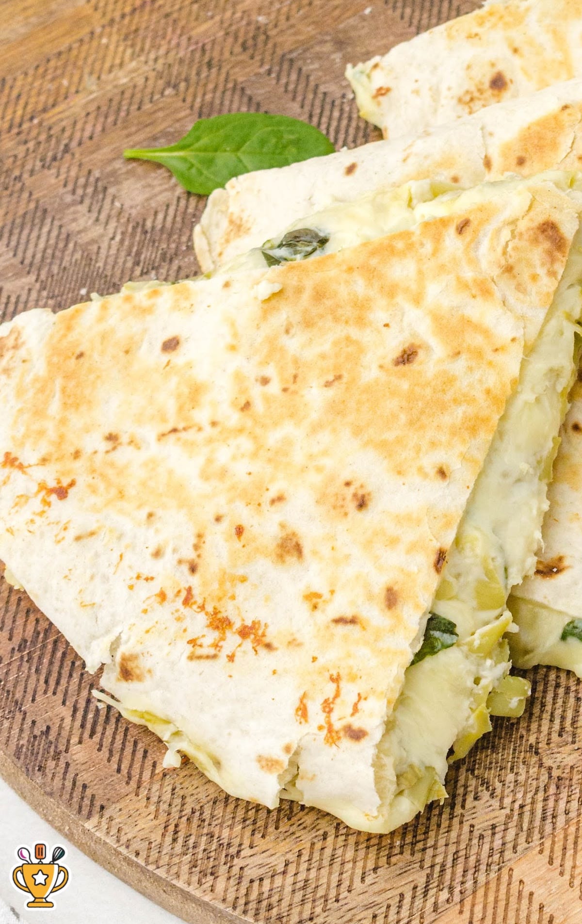 a piece of Spinach Artichoke Quesadilla
