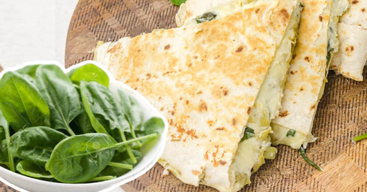 pieces of Spinach Artichoke Quesadilla on a board