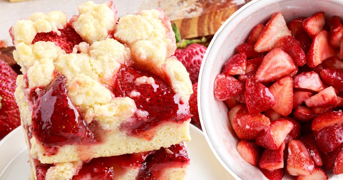 two pieces of Strawberry Pie Bars and strawberry pieces in a bowl