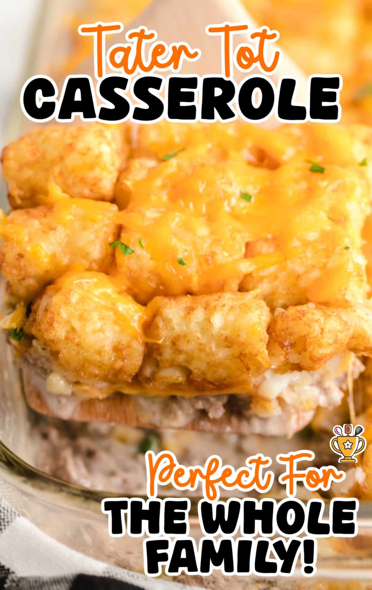 Front-close image of a scoop of tater tot casserole lifted from the dish showing the cheesy topping and creamy inside.