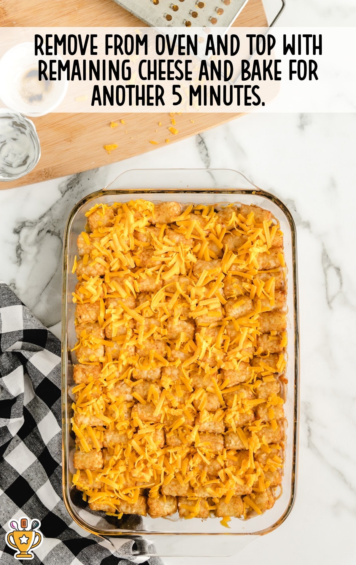 Casserole removed from oven, topped with extra cheddar cheese, and ready for the final 5-minute bake.