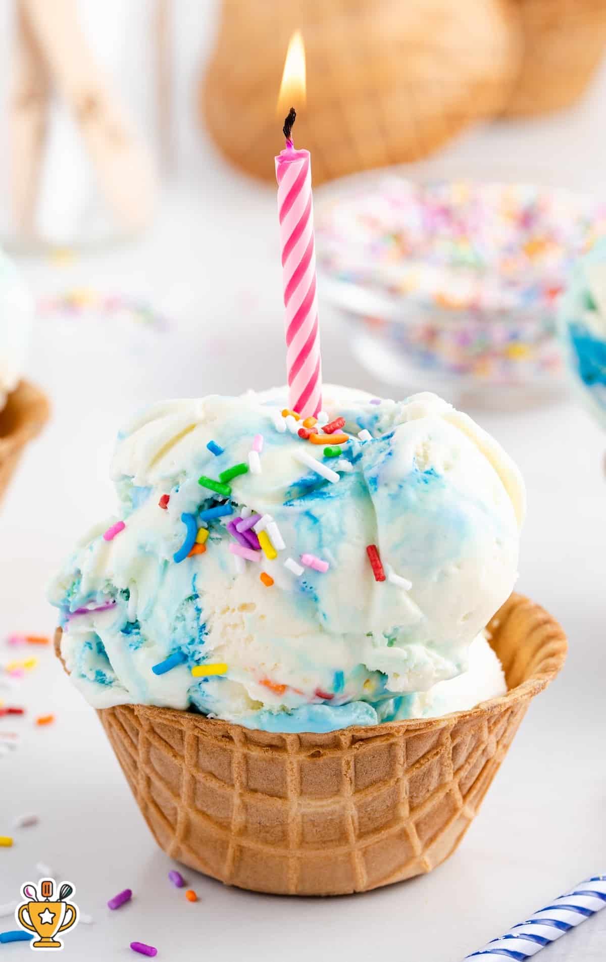 No Churn Birthday Cake Ice Cream with a candle on top